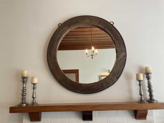 Large mirror made from the wheel of an old carriage